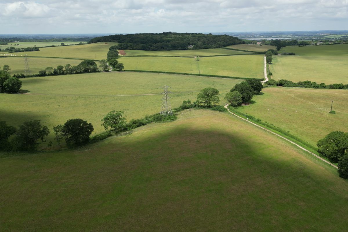 Cloud shadows over the fields and copses along the course
